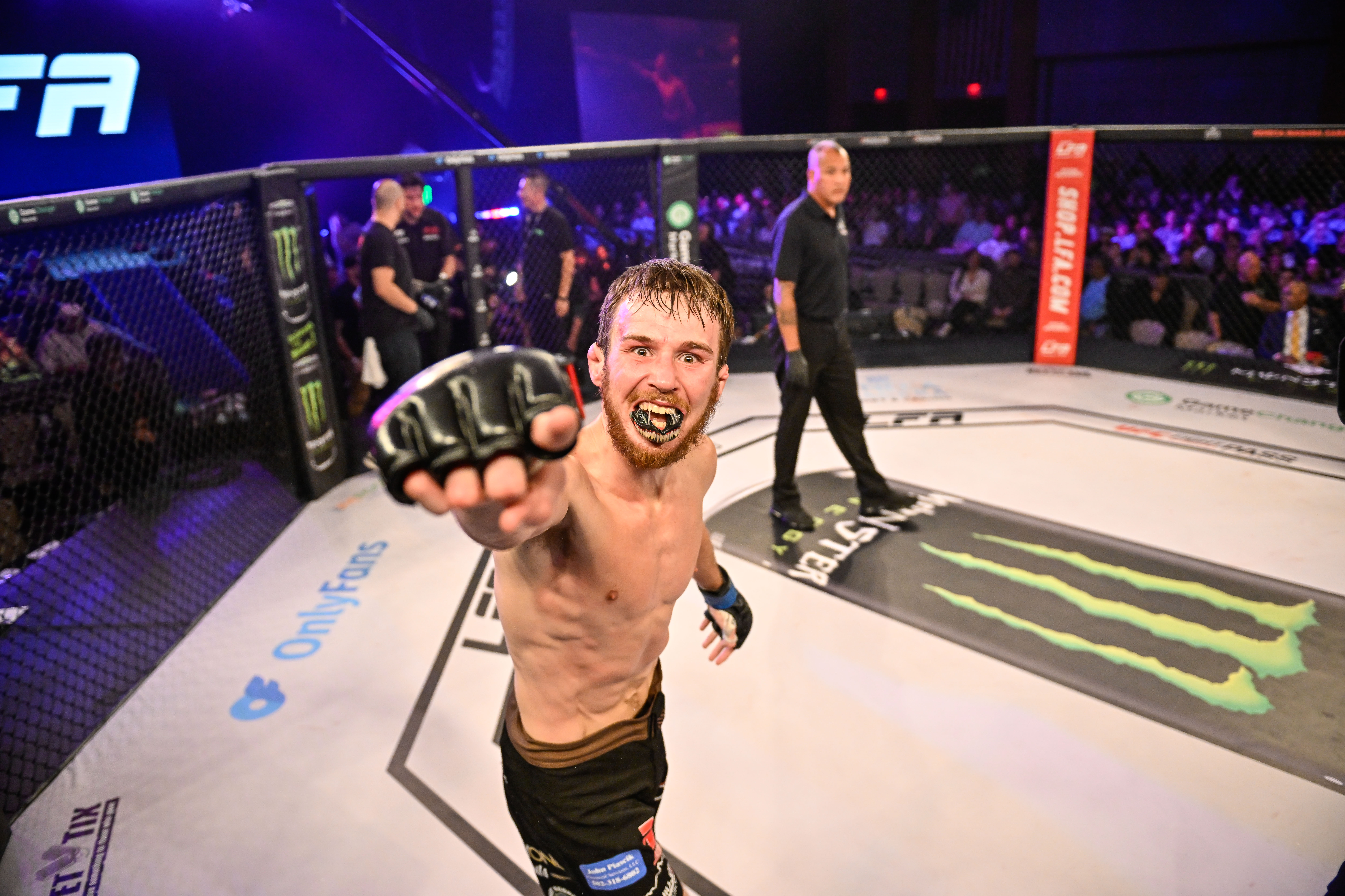 Lance Lawrence points at the camera in the heat of the moment after winning at LFA 194.