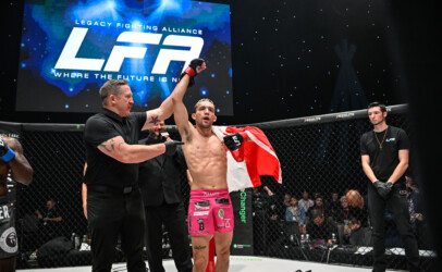 Lozej get's his hand raised at LFA 193 with the Canadian flag wrapped around his shoulders