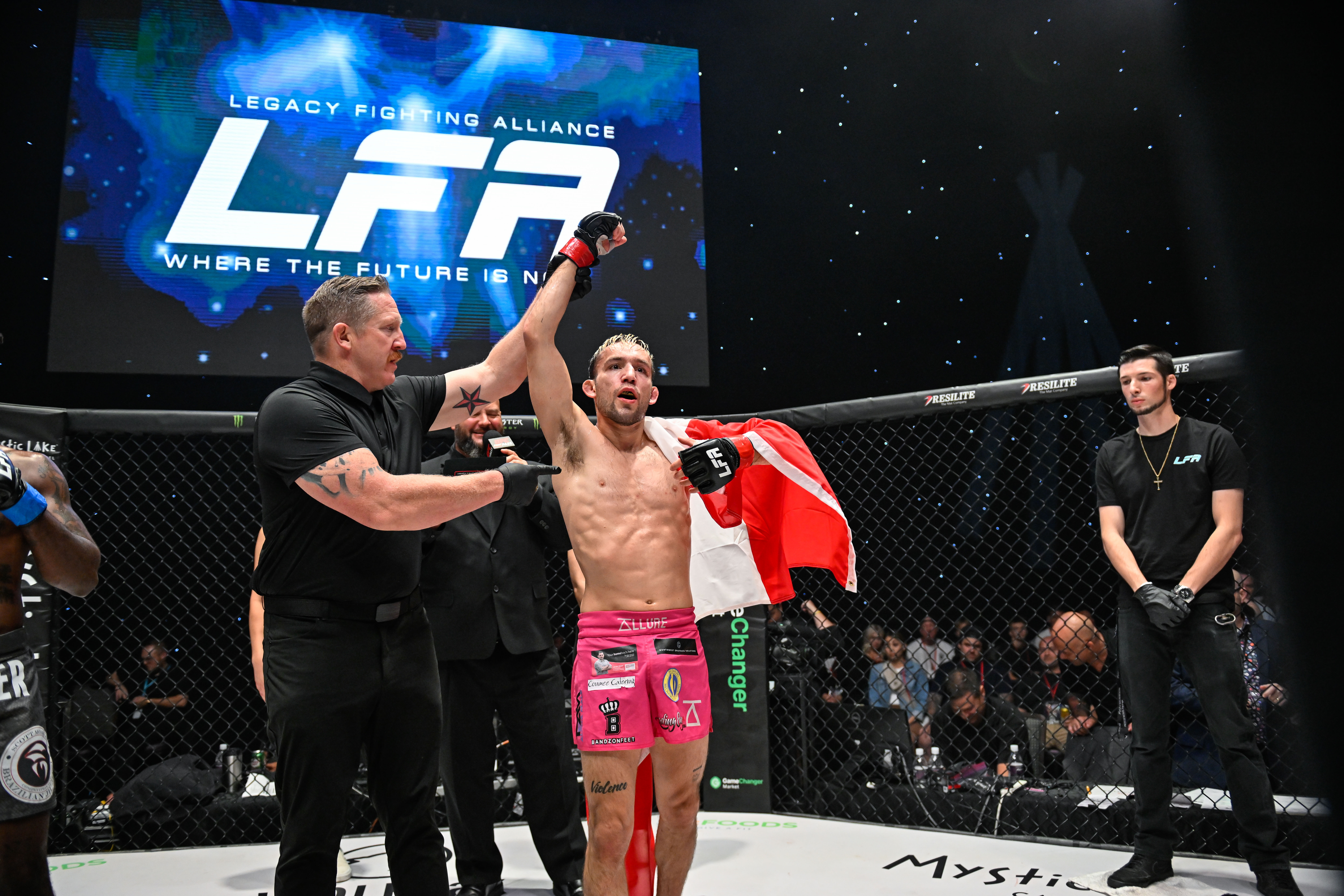 Lozej get's his hand raised at LFA 193 with the Canadian flag wrapped around his shoulders