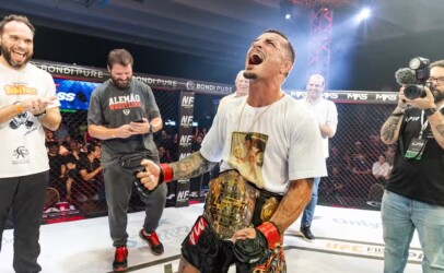Vinicius Pires celebrates with the belt around his waist after earning the title.