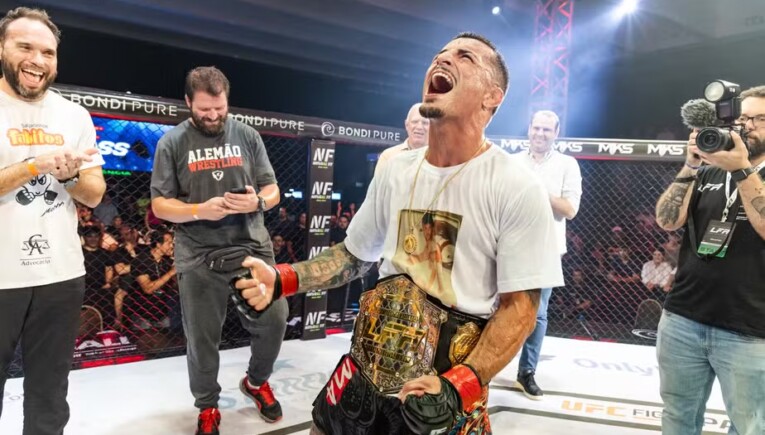 Vinicius Pires celebrates with the belt around his waist after earning the title.
