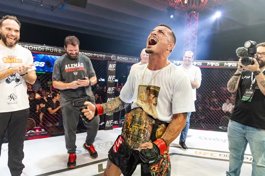 Vinicius Pires celebrates with the belt around his waist after earning the title.